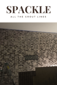faux exposed brick wall made from brick wall panels with spackle covering all the faux grout lines