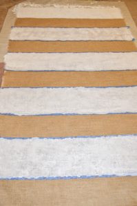 painting white horizontal stripes onto diy burlap curtains
