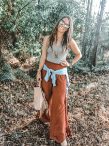 Blogger- Amy Keene, standing in palazzo pants and tank top