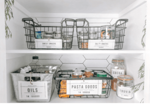 an organized pantry with beautiful labels on each bin