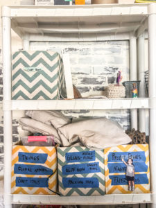 diaper boxes wrapped in fabric hold up as organizing bins