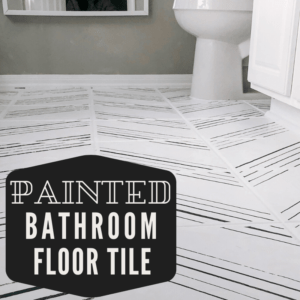 Painted bathroom floor tile with a herringbone stencil