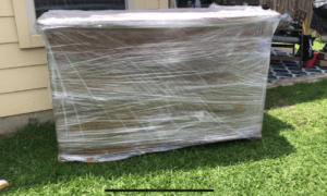 Dresser wrapped in saran wrap while citristrip sets