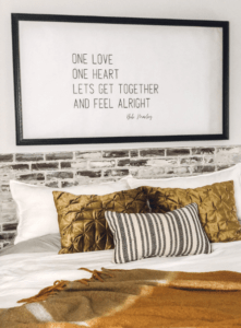 DIY Quote Print of song lyrics hung above the bed in a large frame