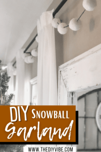 DIY Snowball Christmas Garland draped across curtain rod