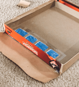 Wrap board game boxes in craft paper