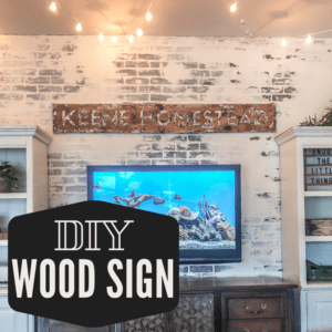 A DIY Wood Sign Personalized with last name and Homestead... Its rustic and hung above the TV on a DIY faux brick wall.