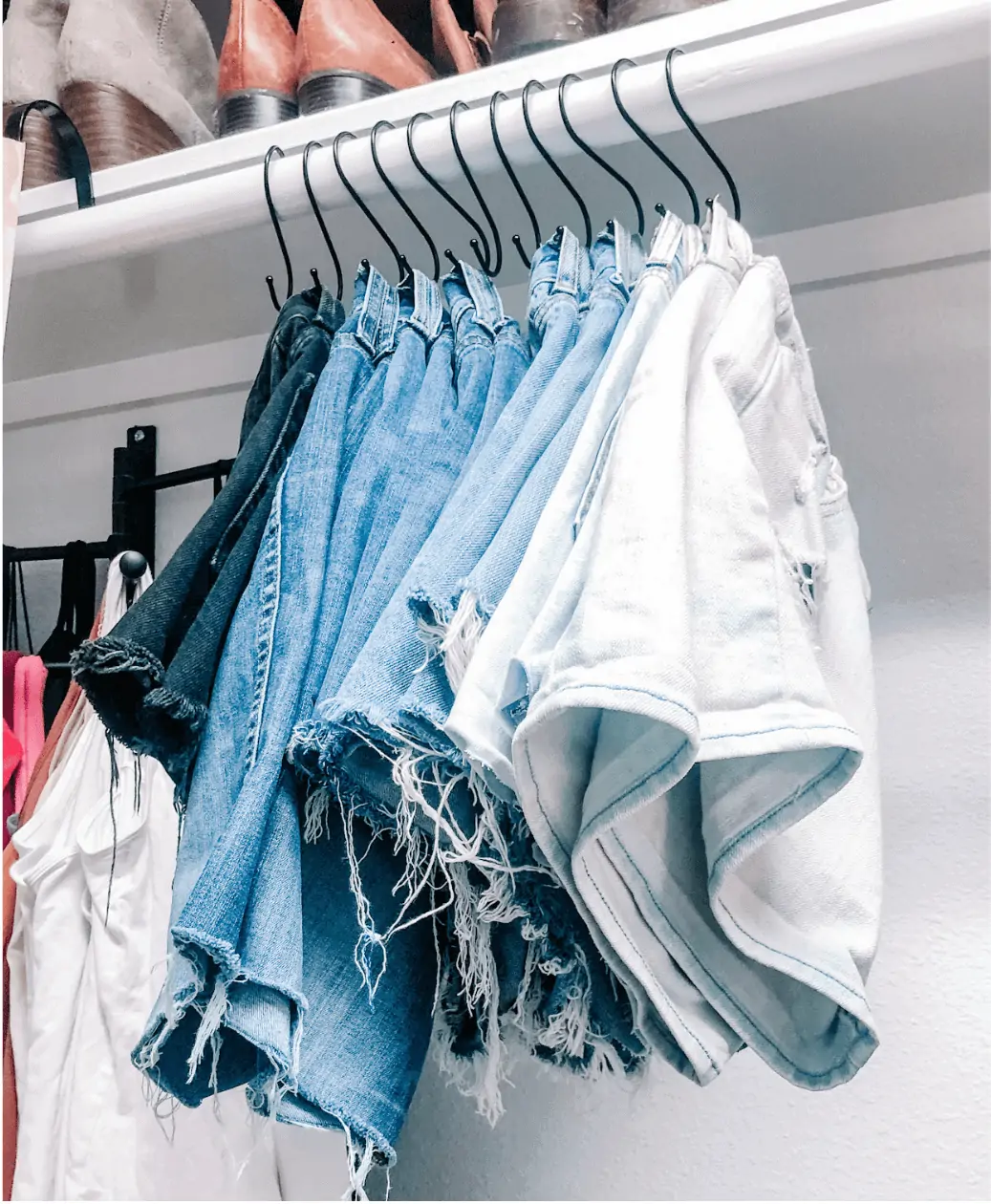 jean shorts organized in closet on S hooks