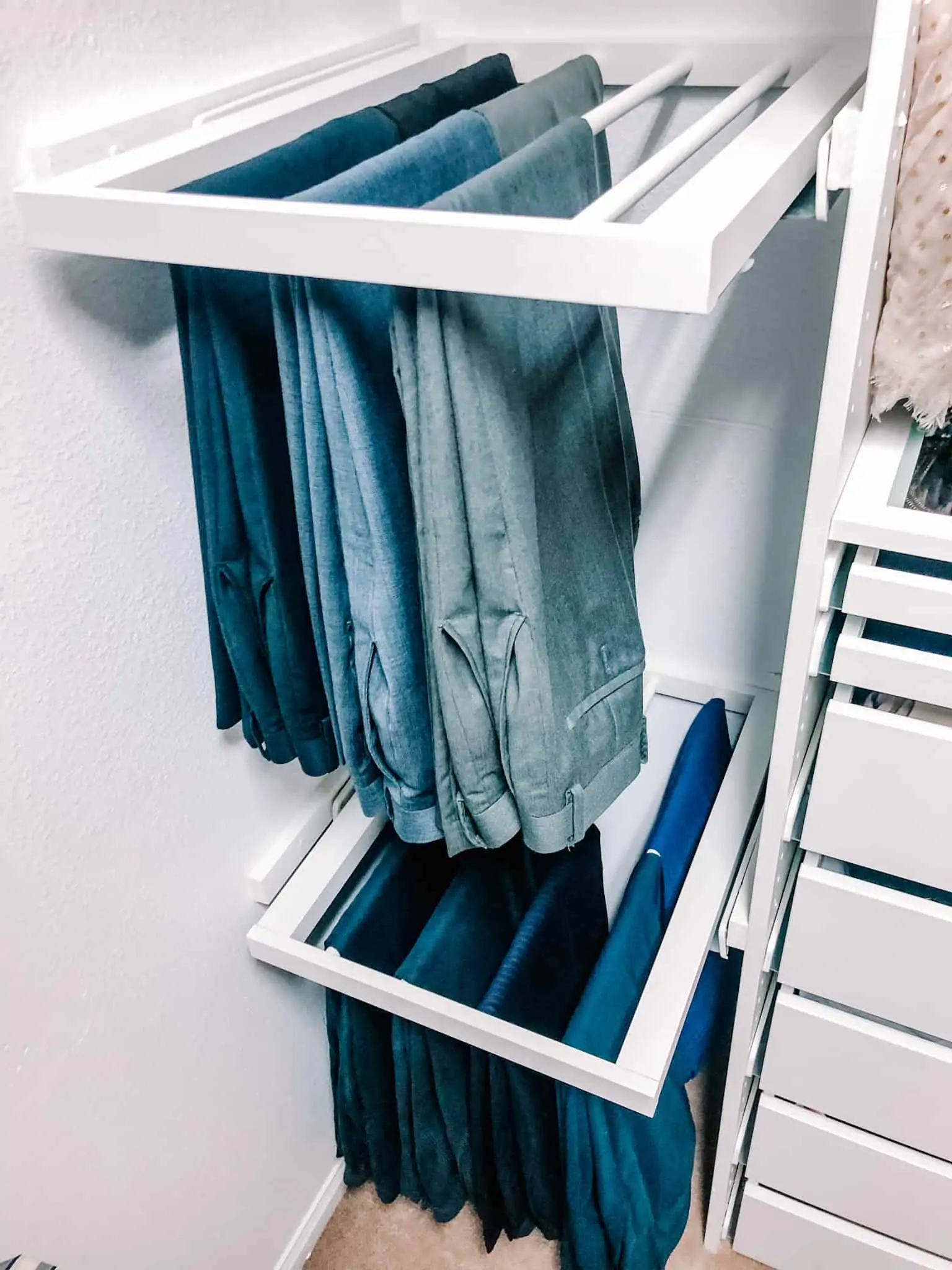 suit pants neatly hung on IKEA komplement pants hangers