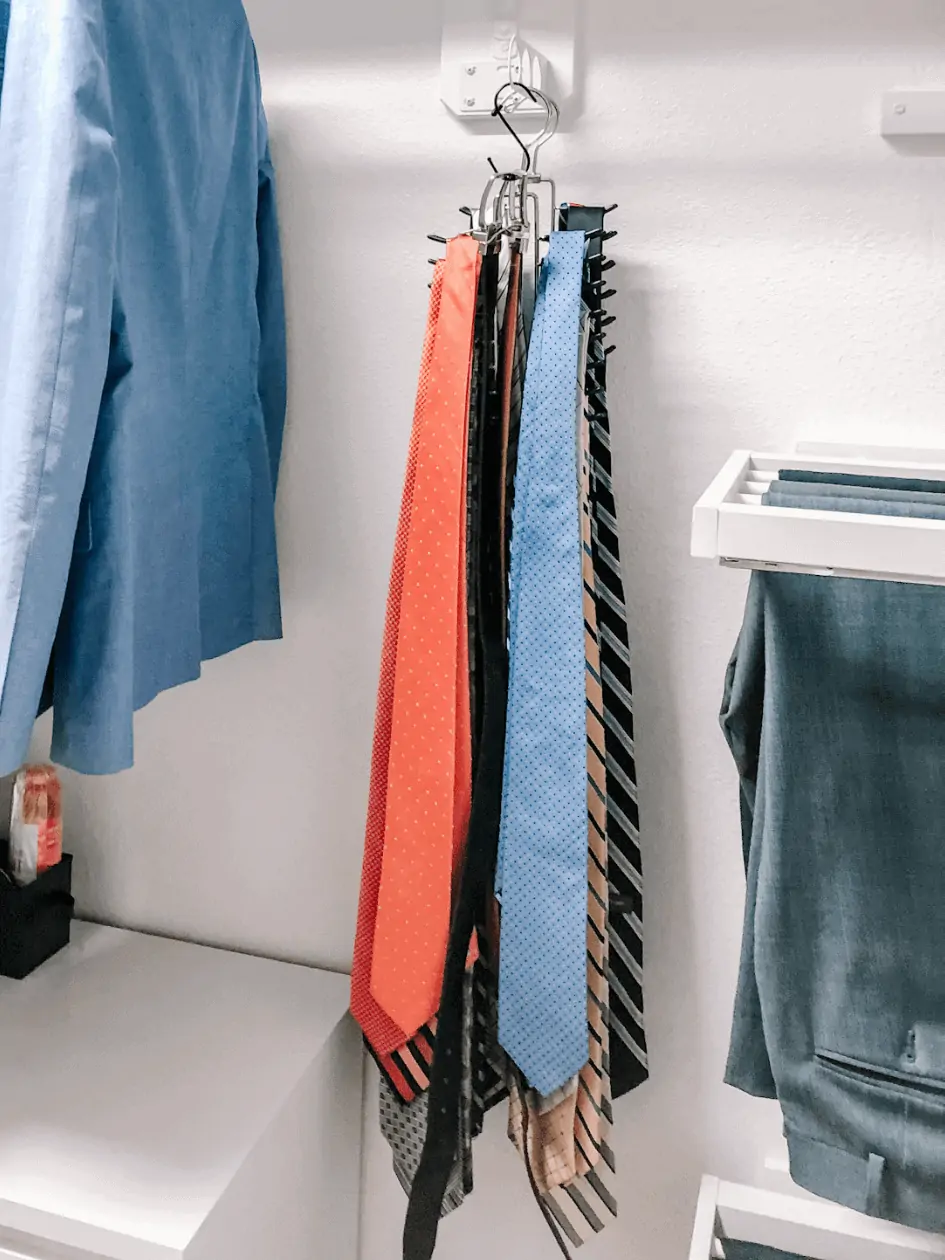 Ties neatly organized in small closet