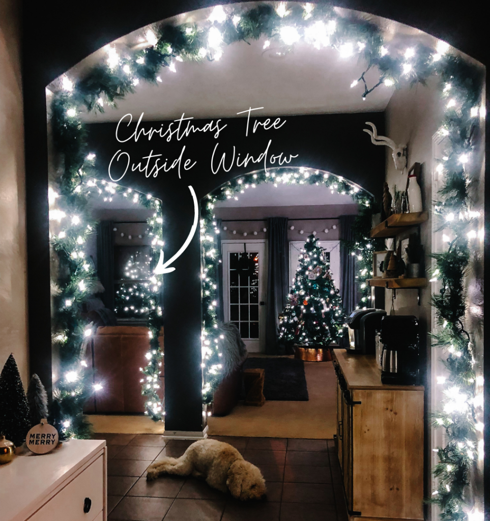 Christmas tree through window in a small house