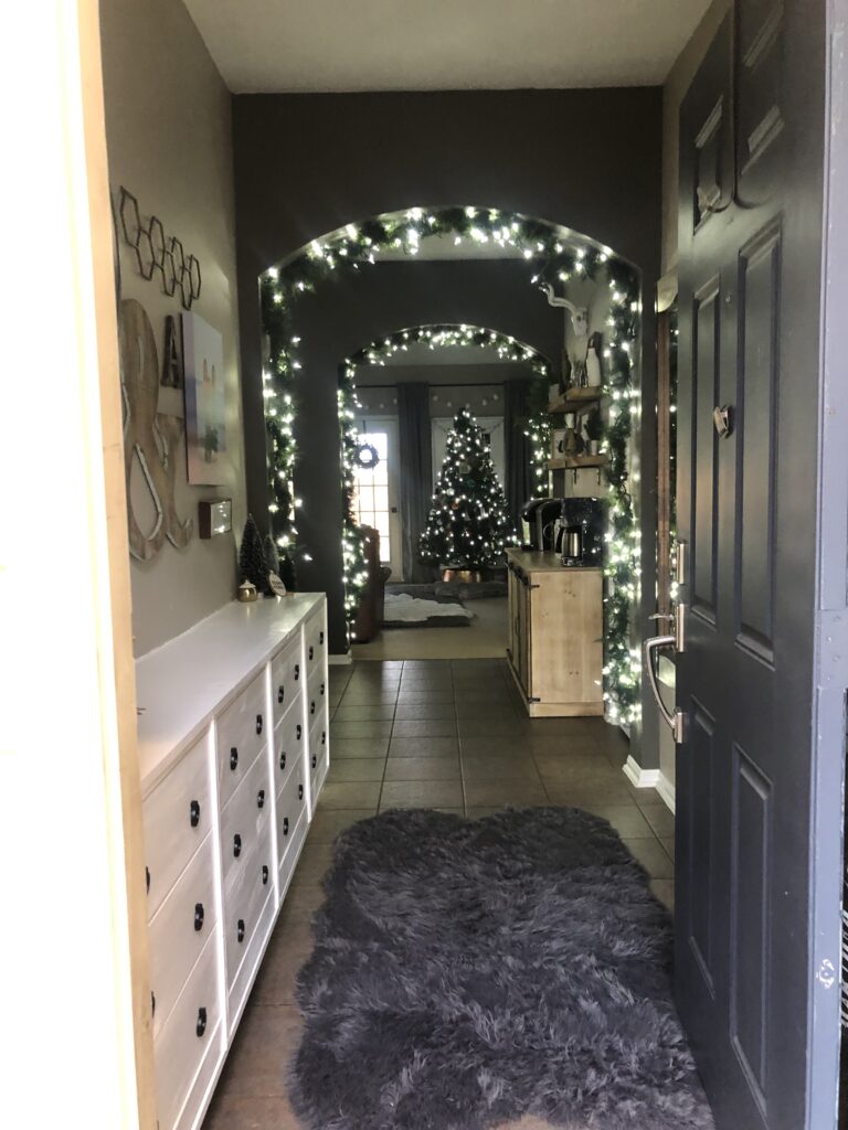 Open front door to see festive indoor Christmas decorations
