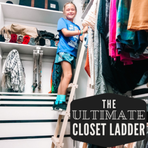 child on tall closet ladder with hooks