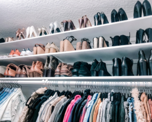 shoe collection organized on high shelves in closet