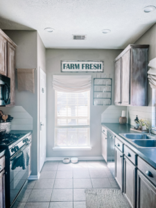 White Roman Shades Hung In the Kitchen